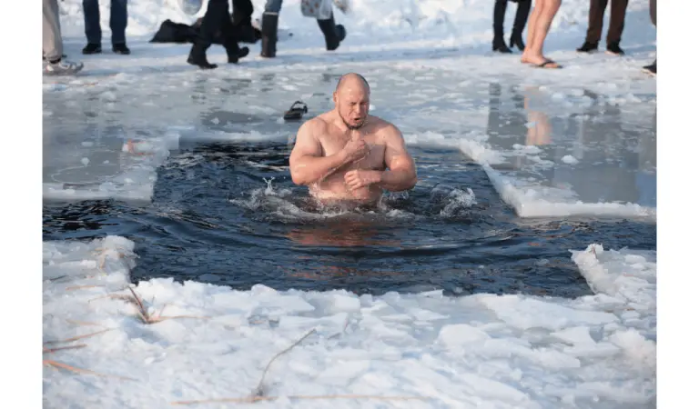 A man plunging into ice water